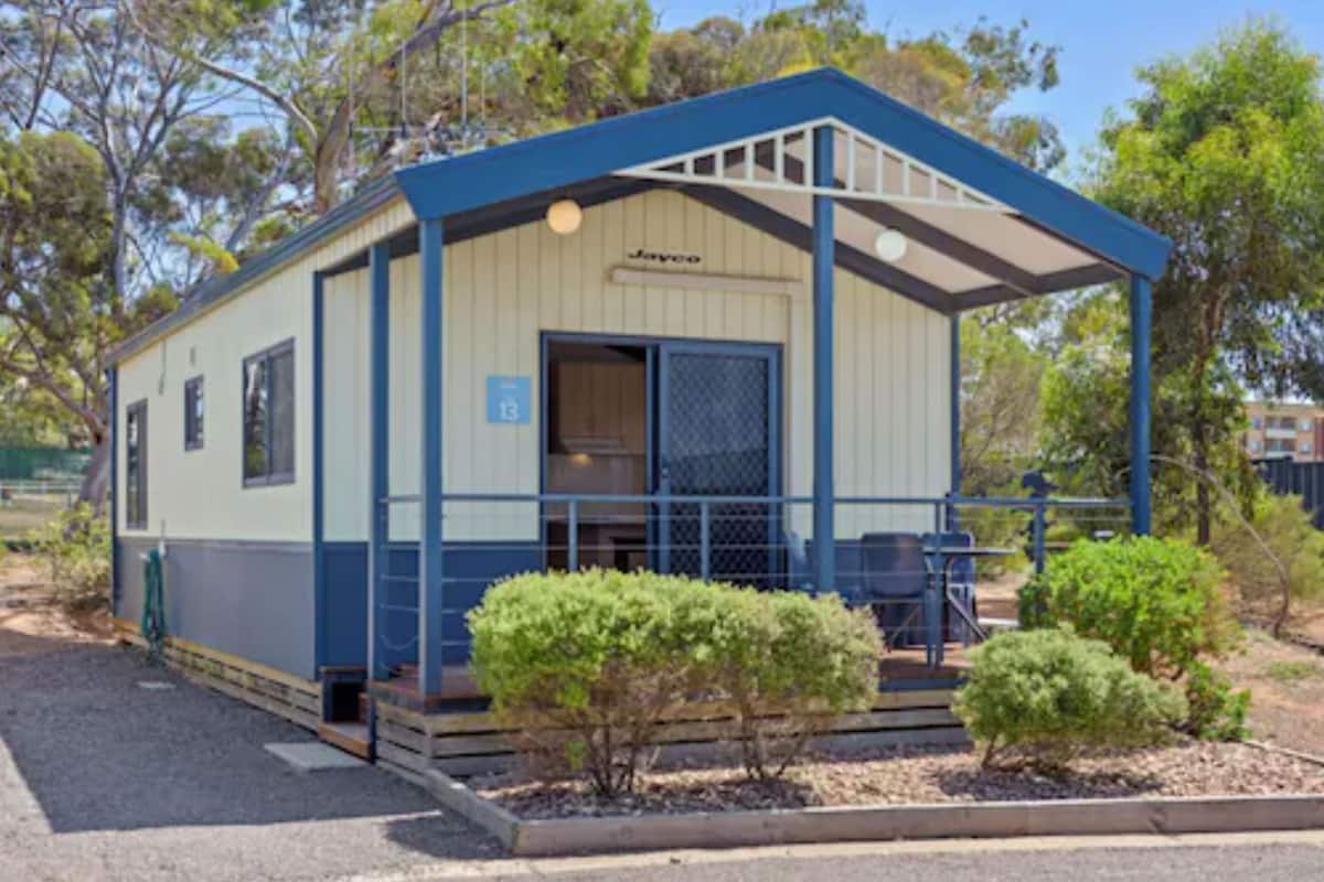 A small, single-story building with a blue roof and beige walls, labeled "Javoo."