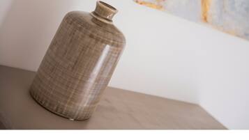 A ceramic vase with a ribbed texture on a wooden surface.