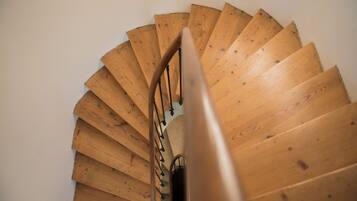 A spiral staircase with wooden steps and metal railings.