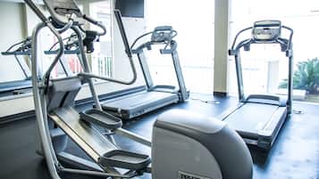 A gym with treadmills and an elliptical machine.