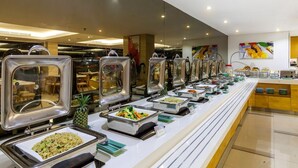 A buffet with various food options, including a section for fried rice. - Kuta Galleria Hotel (Kuta)