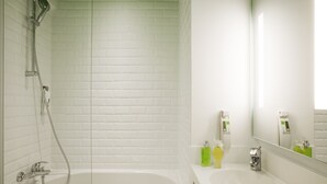 A modern bathroom with a glass-enclosed shower, a white sink, and a mirror. - ibis Styles Paris Buttes Chaumont (Paris)