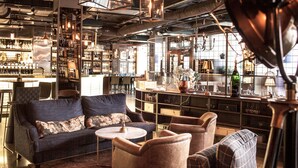A bar area with seating, bar counters, and shelves stocked with bottles. - Best Western Hotel Norrkoping City (Norrköping)