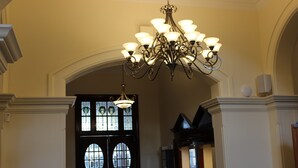 A grand entrance with a large black door, a chandelier, and a decorative archway. - Quality Hotel Regent Rockhampton (Rockhampton)