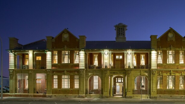 A large, historic building with multiple stories, featuring arched windows and a central entrance labeled "Technical College." - Quality Hotel Regent Rockhampton (Rockhampton)