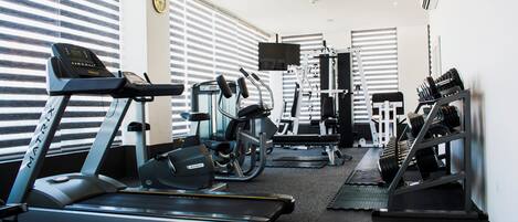 A gym with treadmills, ellipticals, and weight machines.