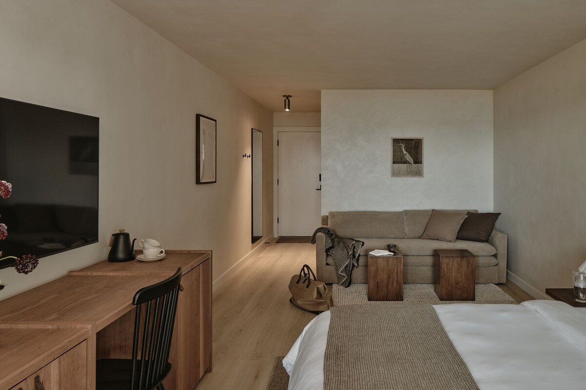Premium bedding, desk, laptop workspace, blackout curtains