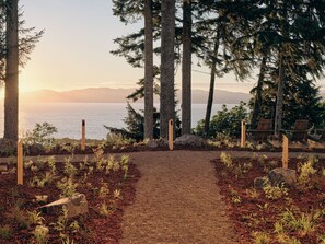 A pathway leading to a seating area with a view of the sea and mountains. - The Herondale Hotel (Astoria)