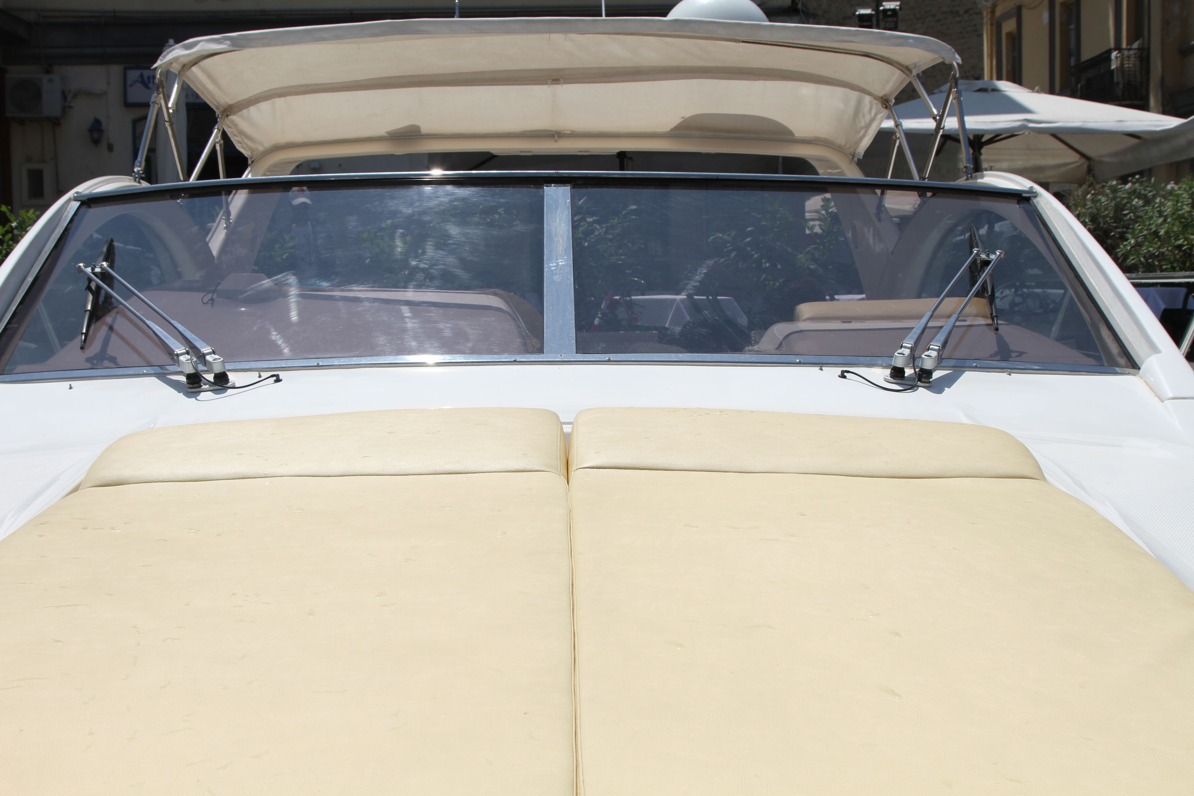 A convertible car with a soft top, beige interior, and a sunroof.