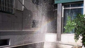 A building with a water feature in front, including a fountain and a small pond with water jets. - Asia Tourist Hotel (Pyeongtaek)