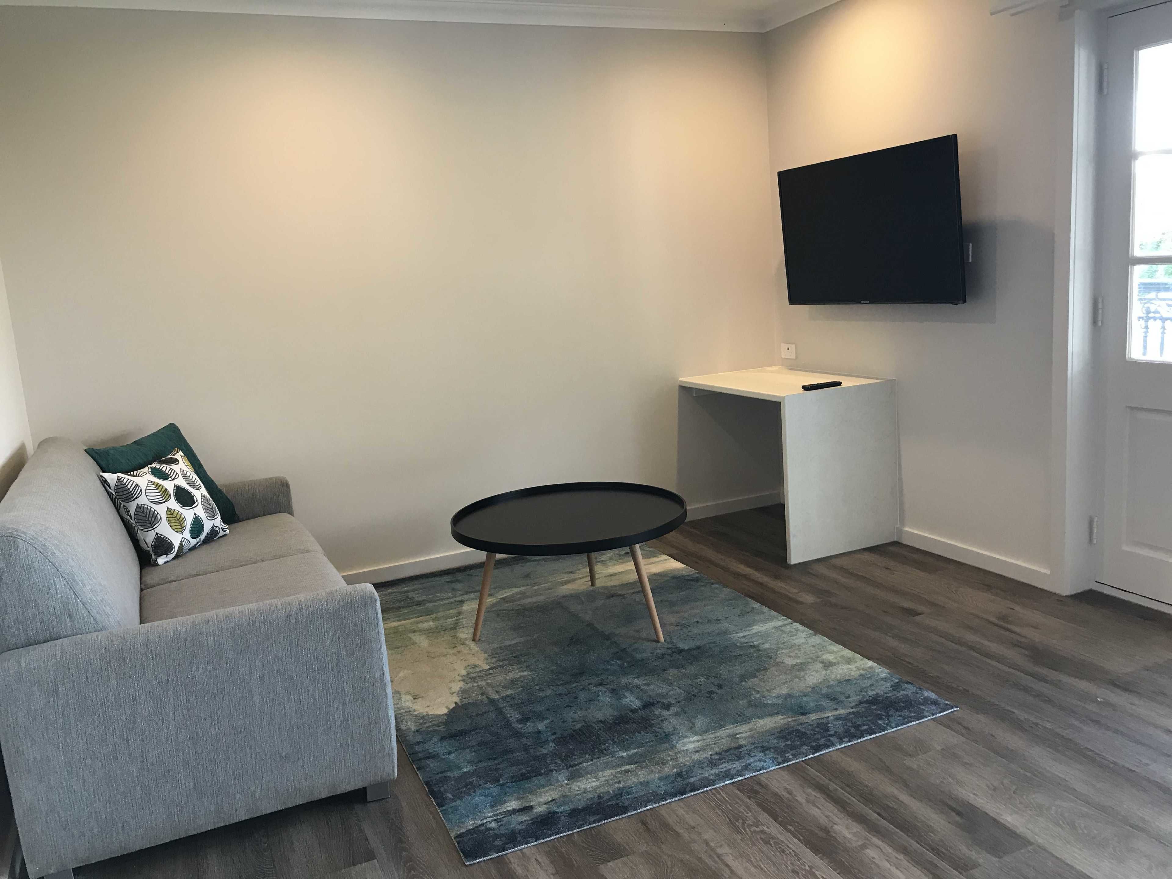 deluxe apartment, 1 bedroom, balcony, ocean view | living area | 50-inch smart tv with digital channels, tv