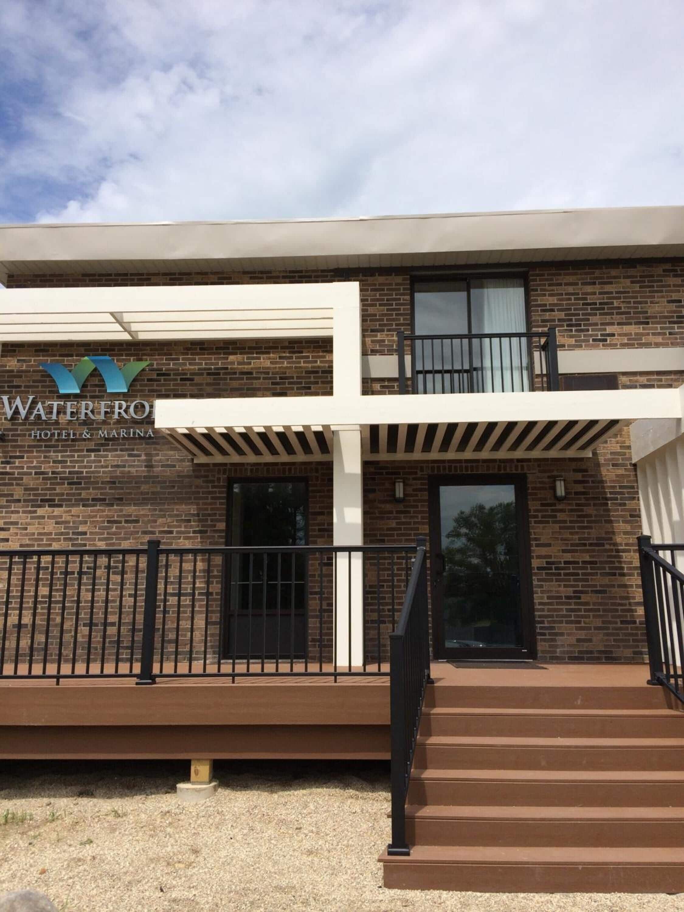 A two-story building with a sign that reads "Waterfront Hotel & Marina."