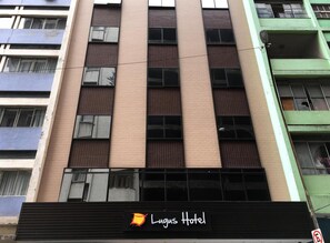 A building with multiple floors, featuring a prominent sign for "Lagus Hotel" at the bottom. - Lugus Hotel (São Paulo)