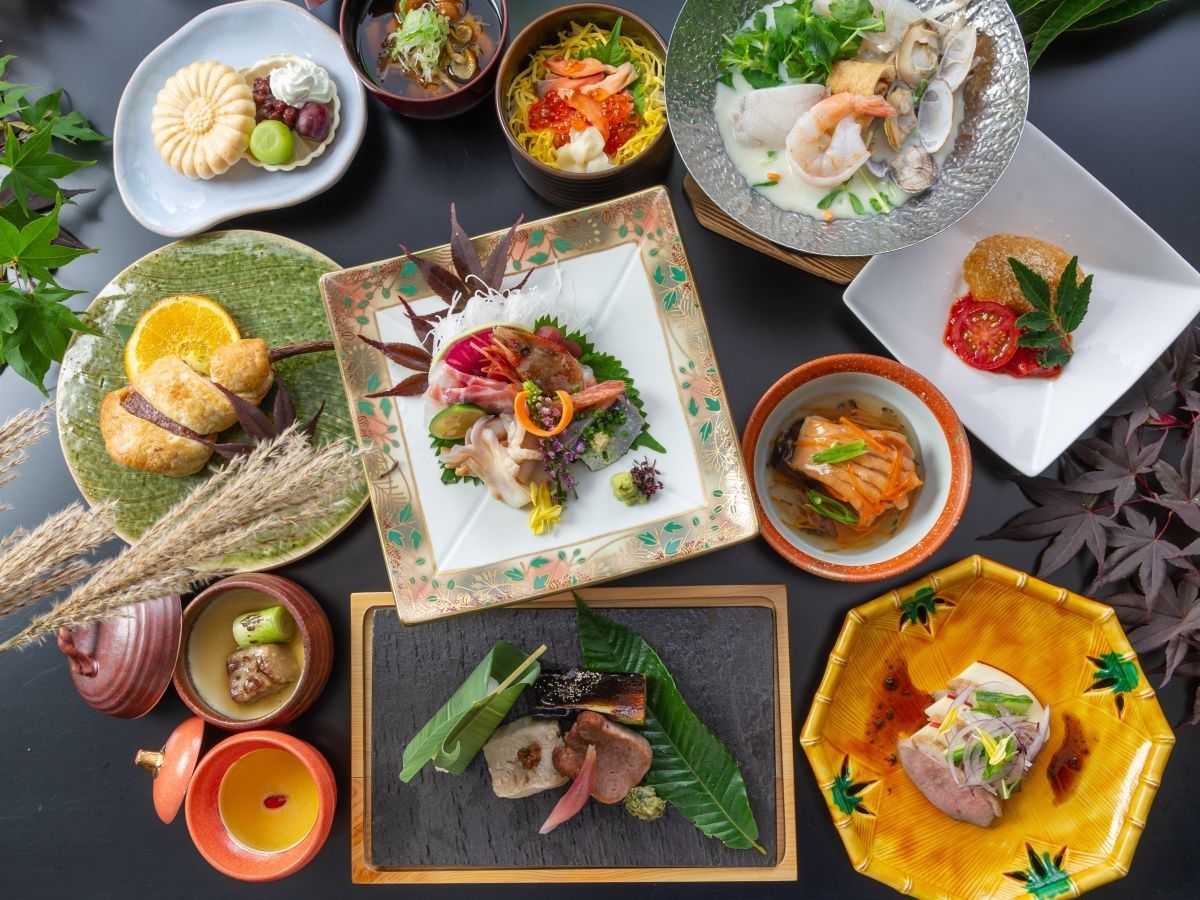 A variety of dishes arranged on a table, including seafood, vegetables, and possibly some desserts.