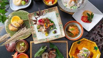 A variety of dishes arranged on a table, including seafood, vegetables, and possibly some desserts.