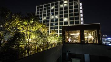 A modern building with multiple floors, large windows, and a glass facade.