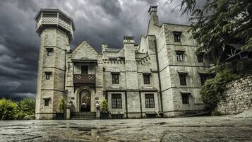 Stately historic building with a traditional design, featuring multiple levels and a prominent tower.
