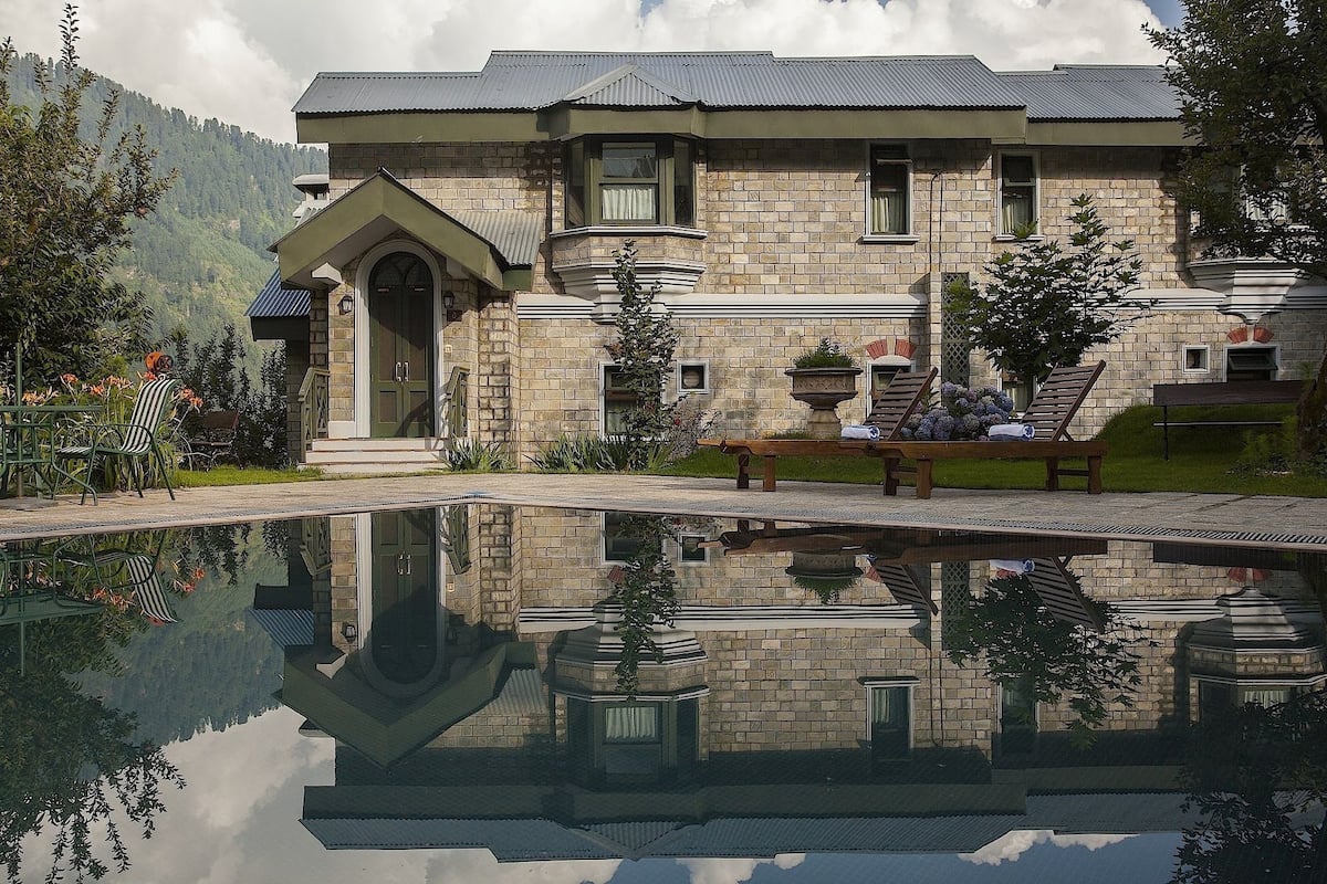 A stone building with a reflective pool in front.