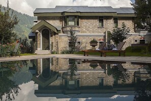 A stone building with a reflective pool in front.