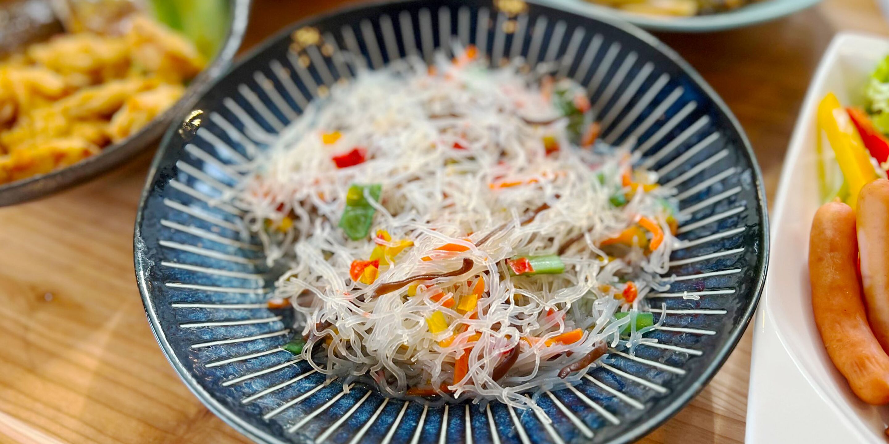 A plate of glass noodles with vegetables.