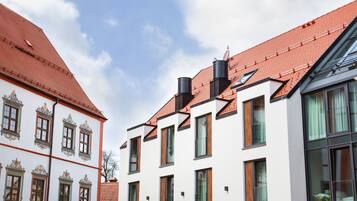 Traditional European-style building with ornate window frames and symmetrical design.