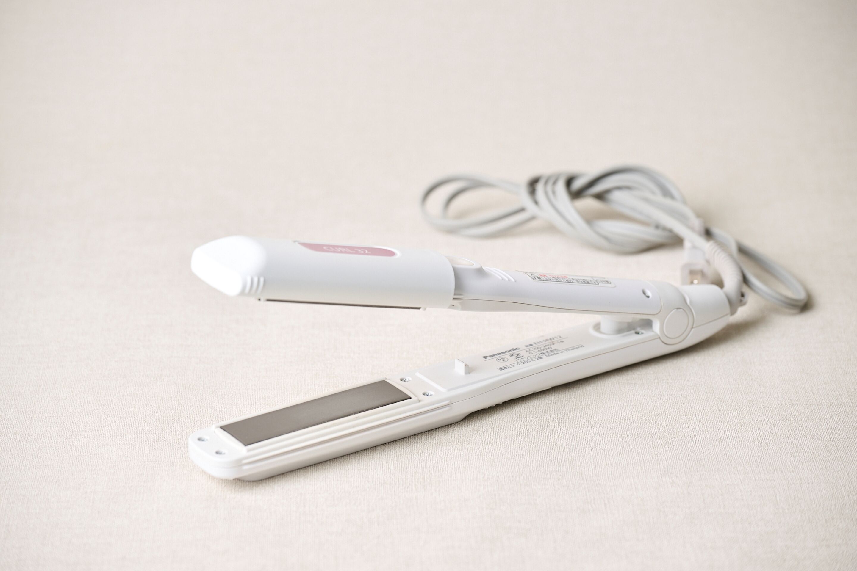 A portable device with a screen and a charging cable.