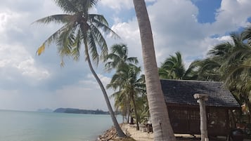 On the beach, white sand, sun loungers, beach towels