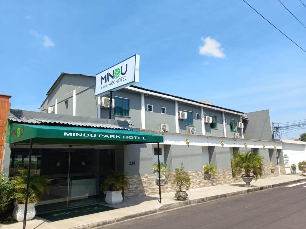 A hotel with a green awning and a sign that reads 'MINDU PARK HOTEL'.