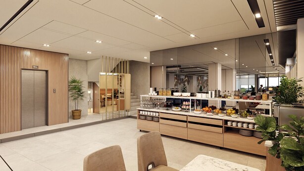 A modern hotel lobby with a reception desk, a seating area with chairs, a buffet counter with food and drinks, and a staircase leading to another floor. - Laxston Hotel by Front One (Yogyakarta)