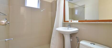A bathroom with a shower, sink, and toilet.