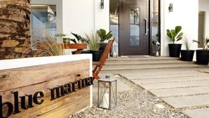 A wooden sign with the text "blue marine" in front of a building entrance. - Blue Marina (Boracay Island)