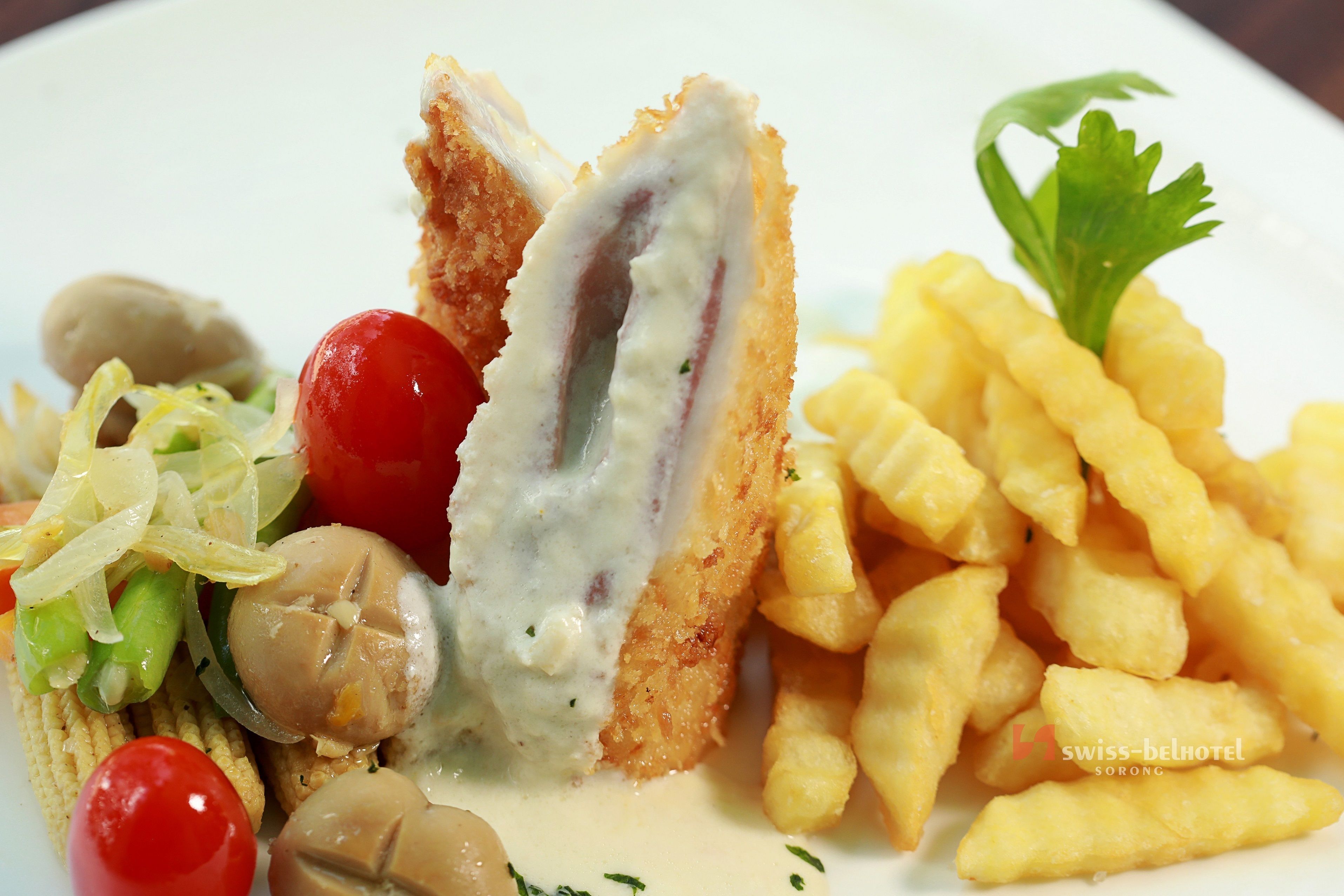 A plate with breaded chicken cutlet, mushrooms, cherry tomatoes, and fries.