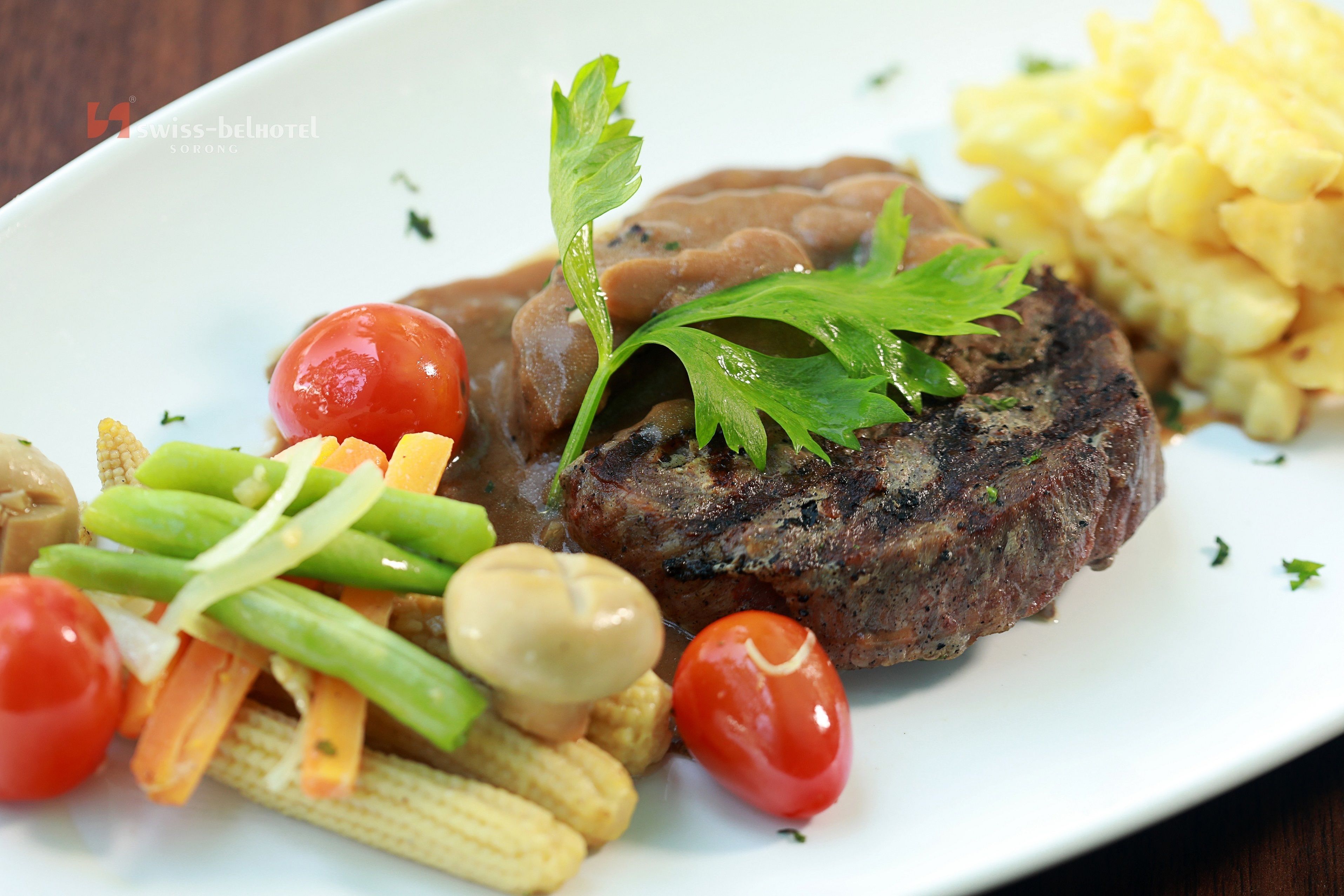 A plate with a steak, vegetables, and mashed potatoes.