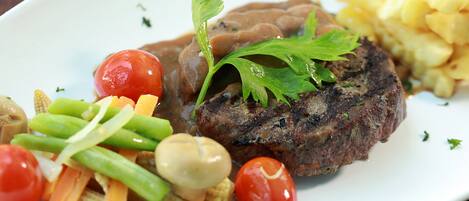 A plate with a steak, vegetables, and mashed potatoes.