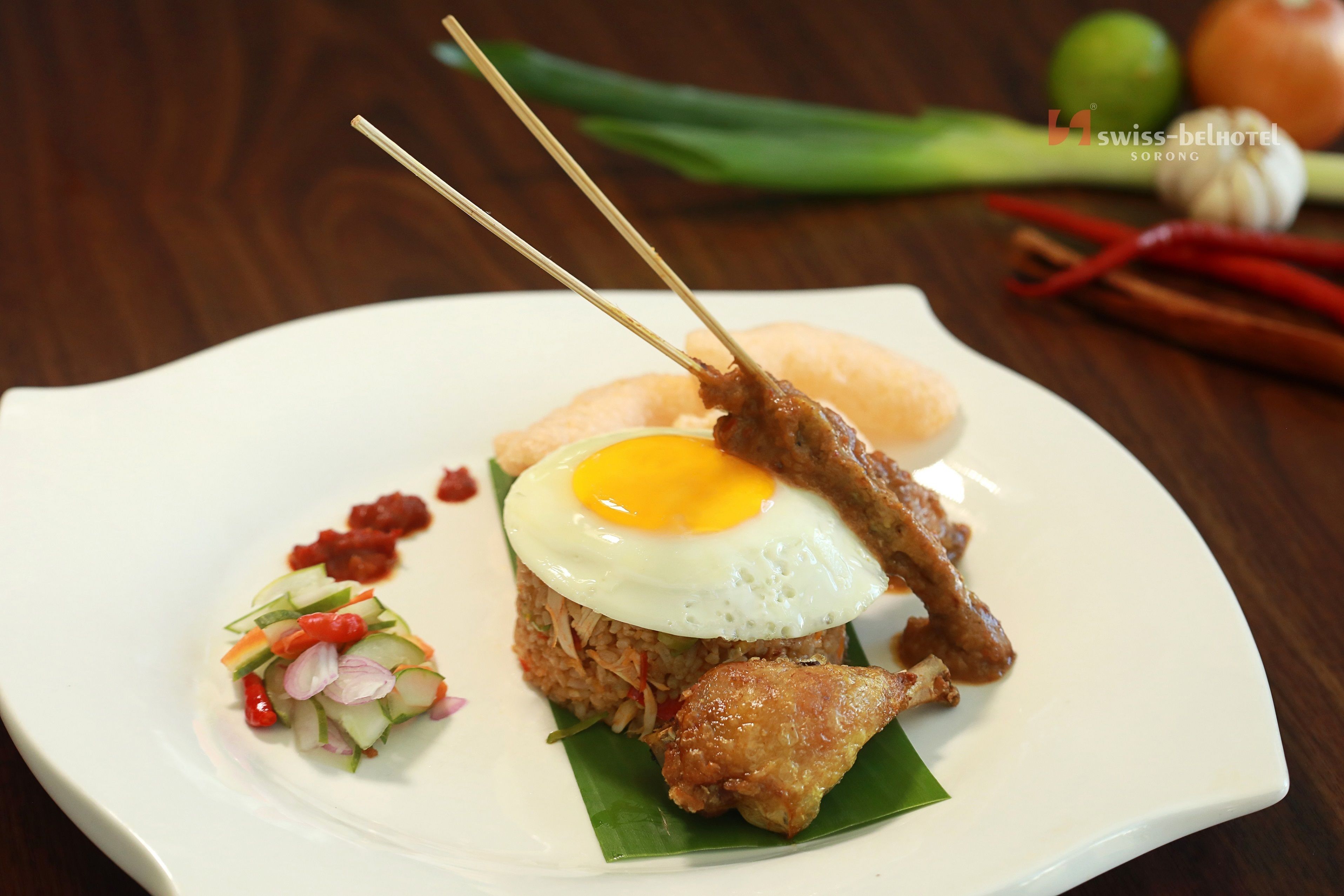 A plate of food with a fried egg, meat, and vegetables.