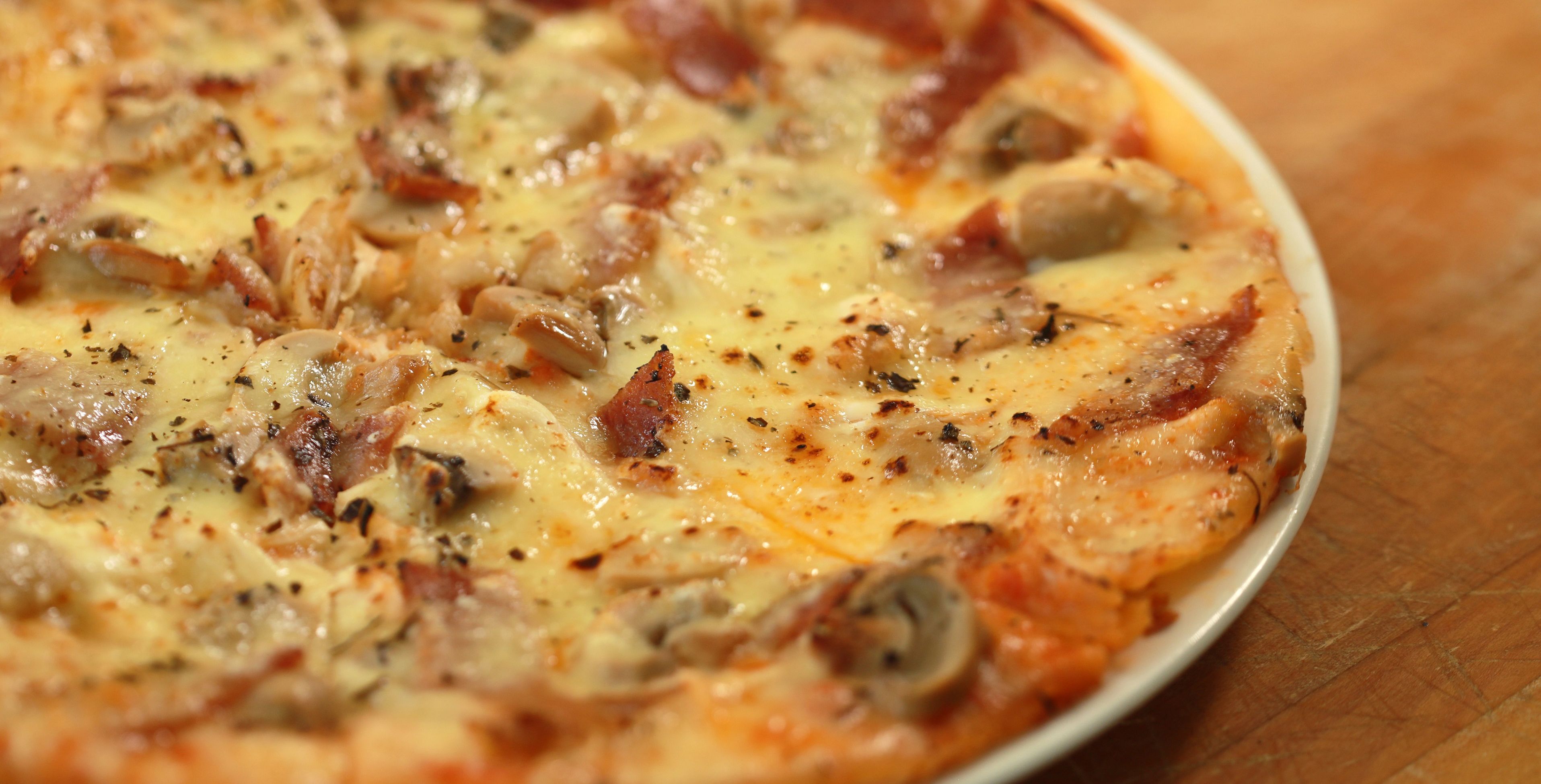 A close-up of a pizza with various toppings.