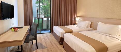 A hotel room with two beds, a desk, a chair, a TV, and a balcony with curtains.
