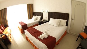 A hotel room with two beds, a desk, a chair, and a door. - Sierra Mar Mazanillo (Manzanillo)