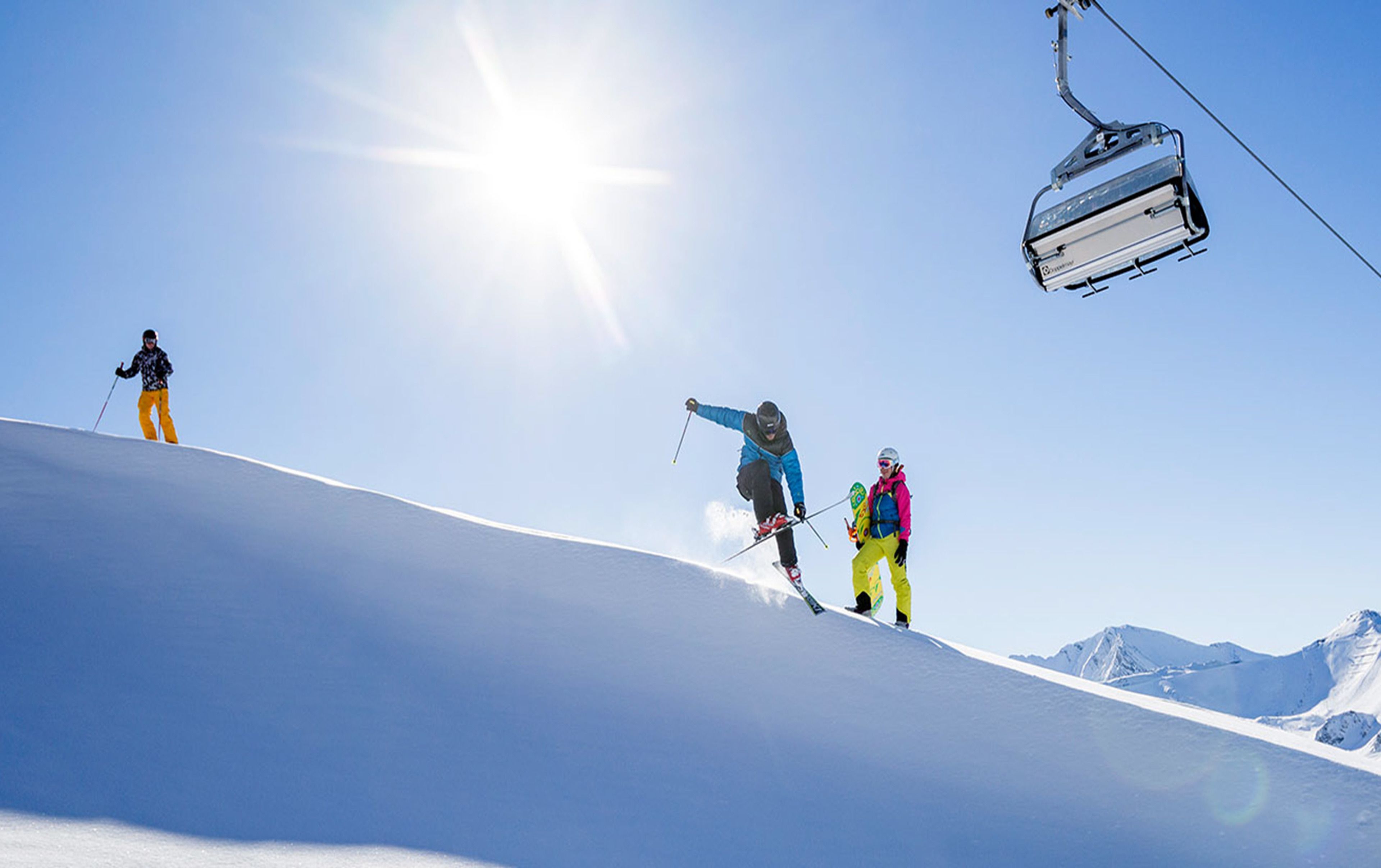 A ski slope with a ski lift and skiers.
