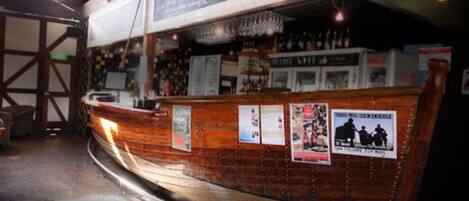 A bar with wooden paneling and a chalkboard menu.