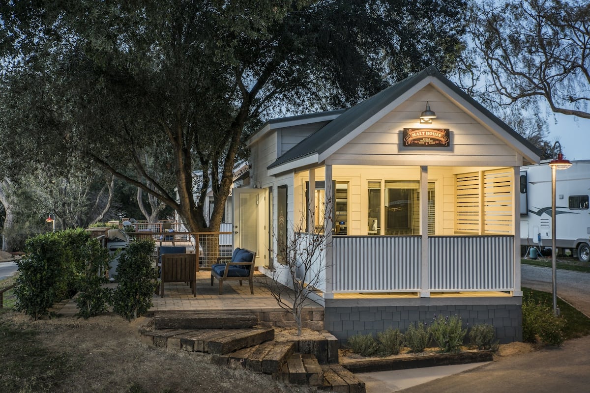 A small, single-story building with a porch and a sign that reads "Malt House."