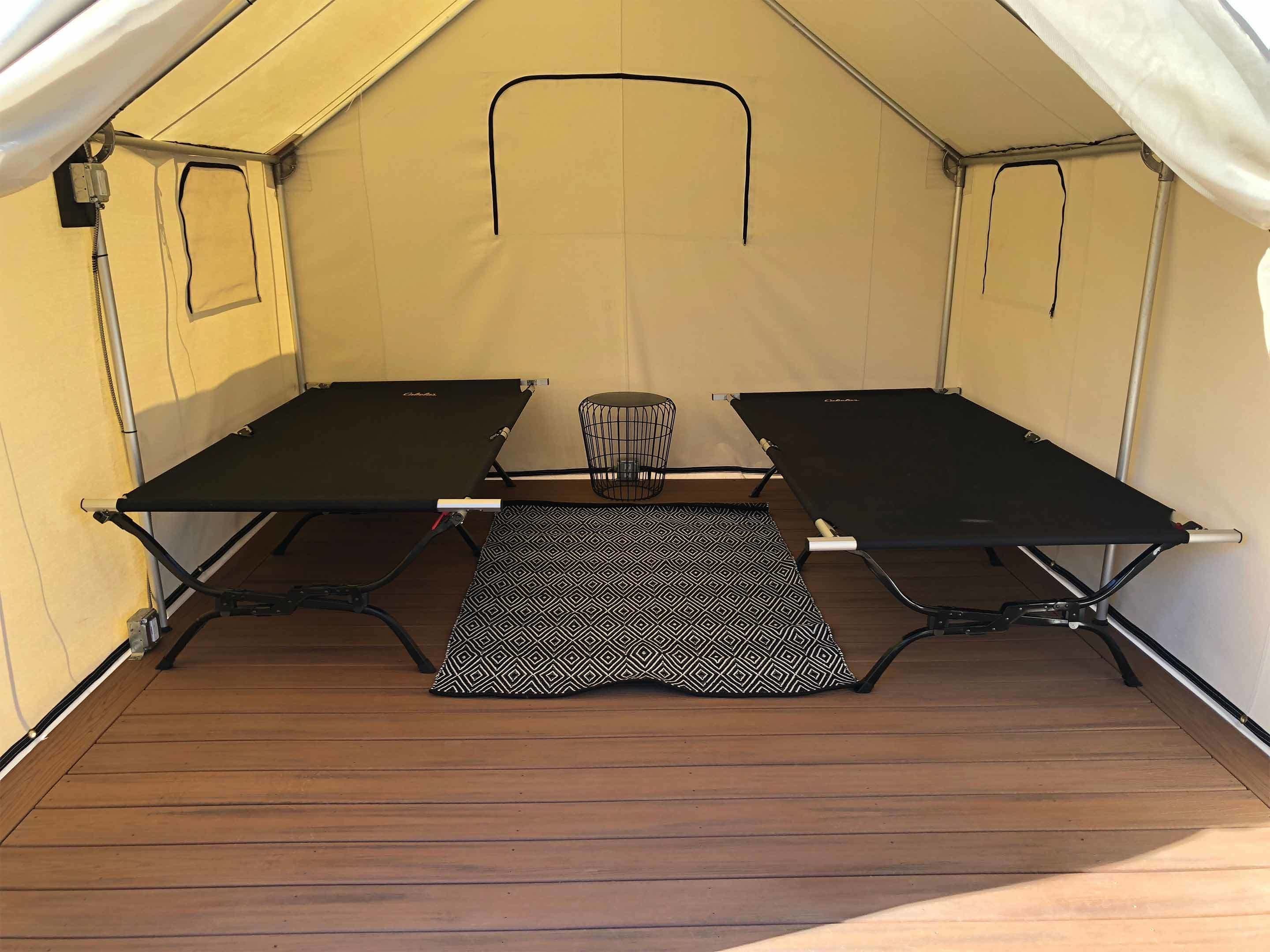 A tent with a table and chairs inside.