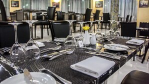 A dining table set with wine glasses, plates, and cutlery. - Mika Convention Center Meanwood (Lusaka)