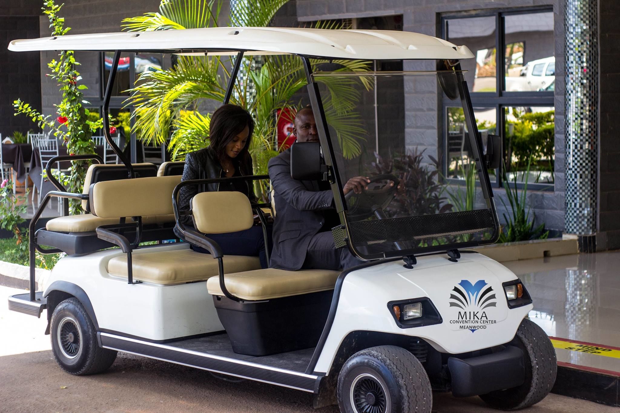 A golf cart with a logo and text indicating it is for the Mika Convention Center in Meanwood.
