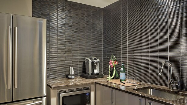 A modern kitchen with stainless steel appliances, a built-in microwave, and a coffee maker. - Loews Chicago Hotel (Chicago)
