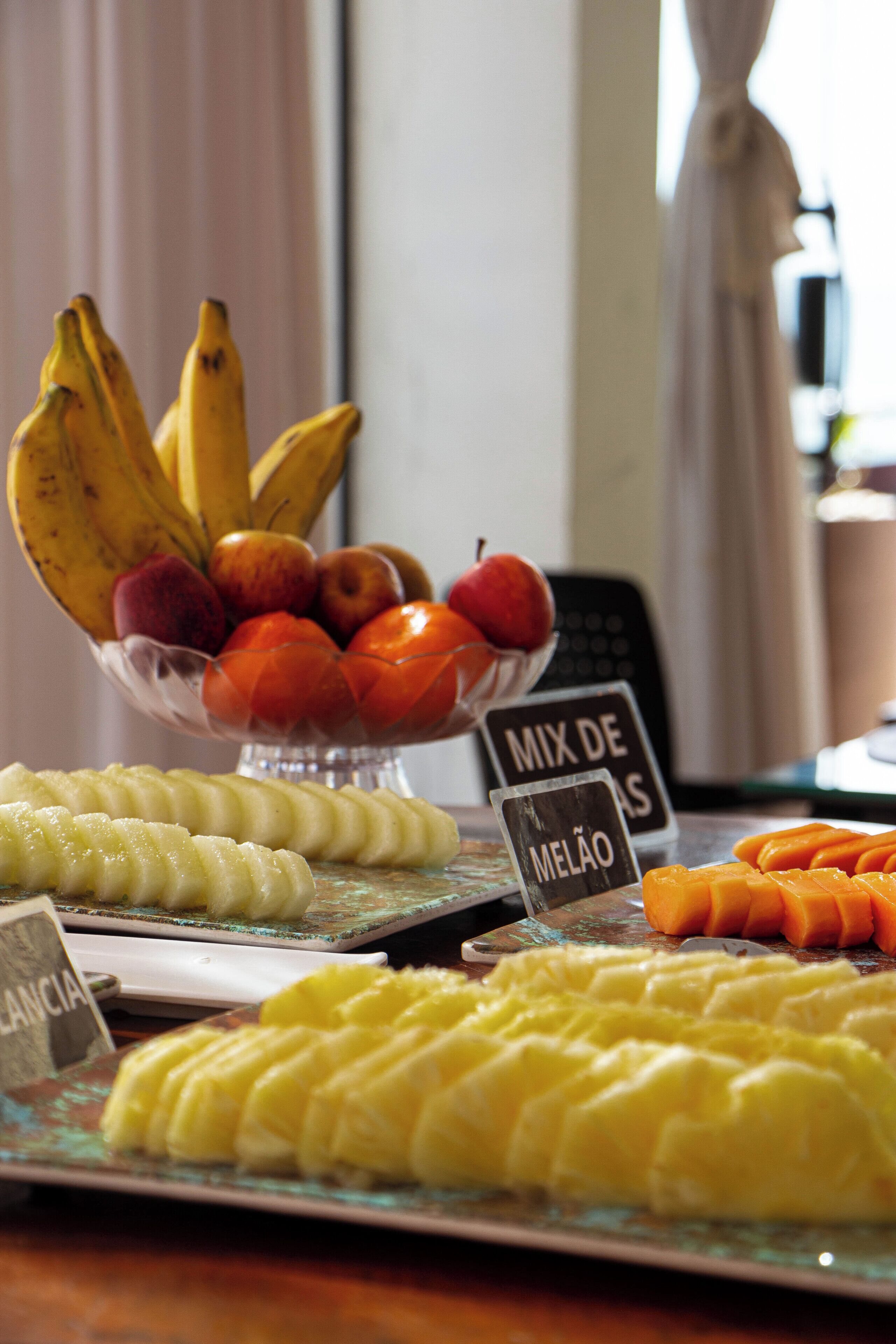 A fruit display with various types of fruits and labels indicating different fruit mixes.