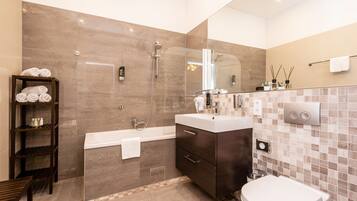 Superior Apartment | Bathroom | Rainfall showerhead, hair dryer, slippers, towels