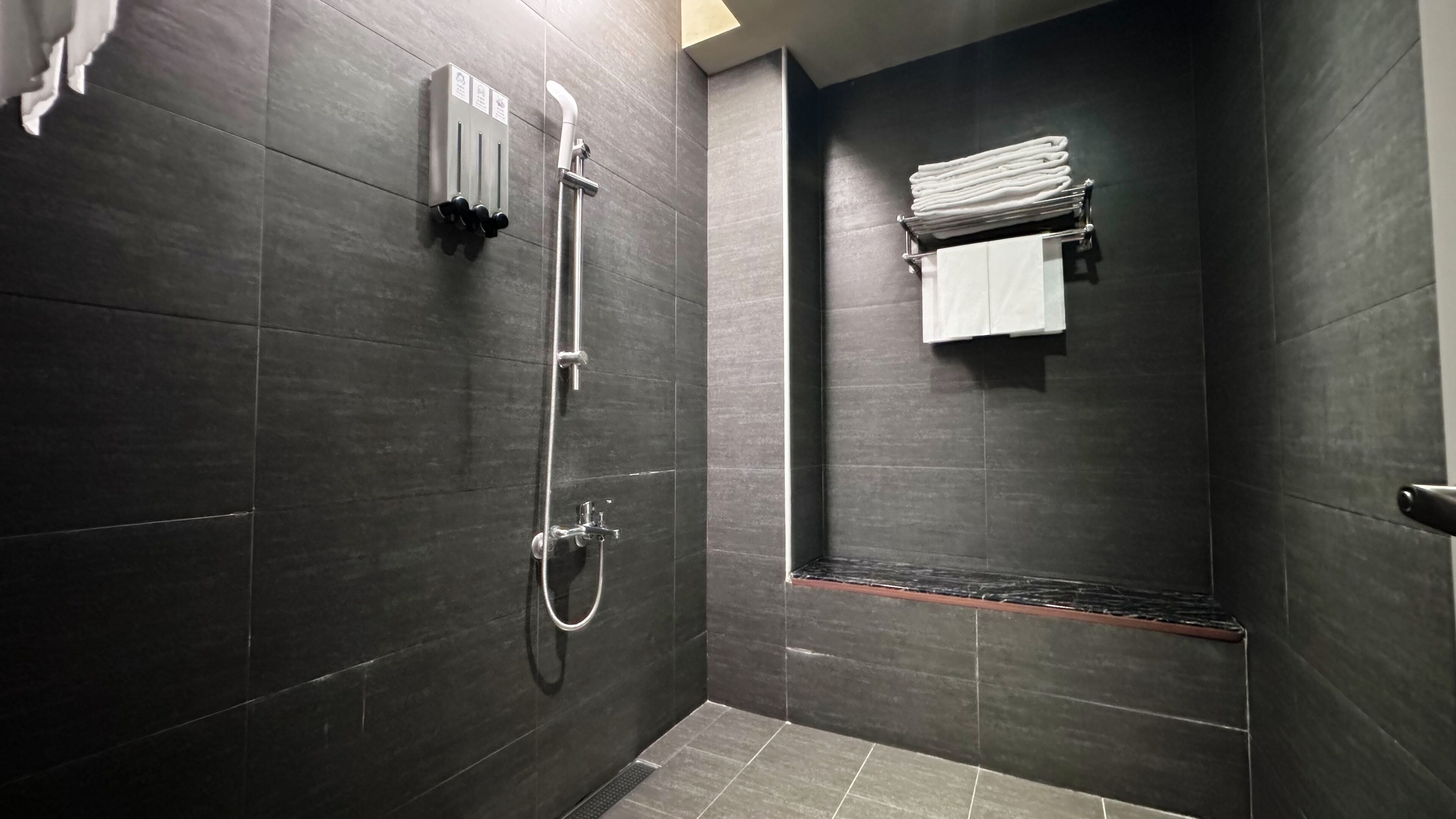 room | bathroom | rainfall showerhead, hair dryer, slippers, towels