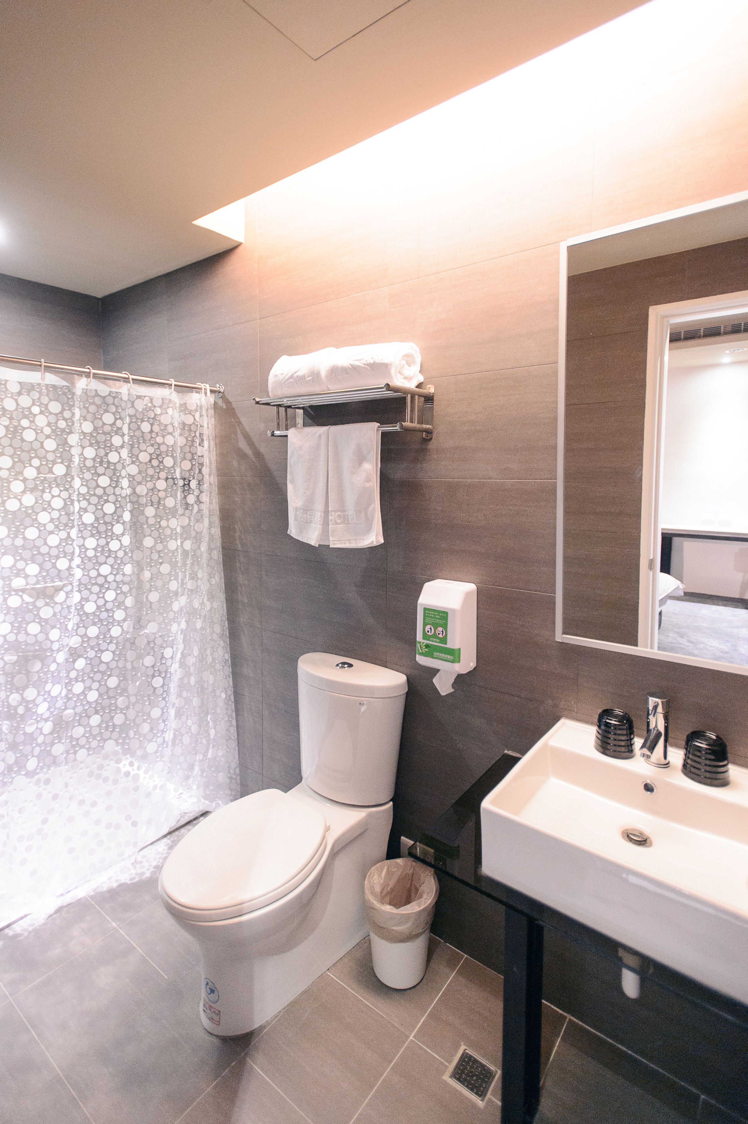 rainfall showerhead, hair dryer, slippers, towels