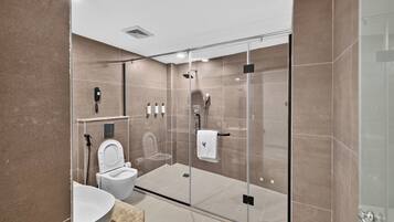 Deluxe Suite, 1 King Bed | Bathroom | Combined shower/tub, hair dryer, bathrobes, slippers